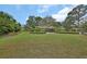 Large front yard with beautiful lawn, mature trees, shrubs, and landscaping around the property at 2427 Beck Cir, Deltona, FL 32738