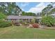 Charming single story brick home with a meticulously landscaped front yard and colorful foliage at 2427 Beck Cir, Deltona, FL 32738