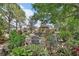 Gardens with stone patio, chairs, plants, flowers, and a tool shed at 2427 Beck Cir, Deltona, FL 32738
