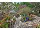Beautiful gardens with a stone walkway, plants, flowers, and decorations at 2427 Beck Cir, Deltona, FL 32738