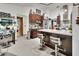 Modern kitchen with dark wood cabinets, granite countertops, stainless steel appliances, and island seating at 2427 Beck Cir, Deltona, FL 32738