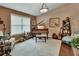 Cozy living room showcasing a piano, window, decorative chair, and plush carpet at 2427 Beck Cir, Deltona, FL 32738