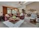 Open-concept living room with a large sectional sofa, accent rug, and stylish décor at 2427 Beck Cir, Deltona, FL 32738