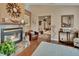 Cozy living room featuring a fireplace with decorative accents and comfortable seating area with light blue rug at 2427 Beck Cir, Deltona, FL 32738