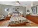 Comfortable bedroom with ceiling fan, wood floors, and leafy tropical bedding at 2427 Beck Cir, Deltona, FL 32738