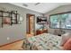 Bedroom with hardwood floors, ceiling fan, and a peek into the ensuite bathroom at 2427 Beck Cir, Deltona, FL 32738