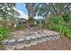 Outdoor seating area surrounded by landscaping and stone hardscaping provides a place for outdoor dining and relaxing at 2427 Beck Cir, Deltona, FL 32738