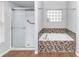 Bright bathroom featuring a tiled soaking tub and a glass-enclosed shower at 2466 Candlewick St, Deltona, FL 32738