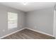 Clean bedroom with wood-look flooring, neutral paint, and a window for natural light at 2466 Candlewick St, Deltona, FL 32738