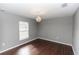 Bedroom features a chandelier and window with natural light at 2466 Candlewick St, Deltona, FL 32738