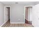 Neutral bedroom with two entryways and wood-look laminate flooring at 2466 Candlewick St, Deltona, FL 32738