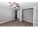 Bedroom with closet and wood-look laminate flooring at 2466 Candlewick St, Deltona, FL 32738