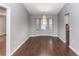 Dining room with hardwood floors, a modern chandelier, and a view of the front yard at 2466 Candlewick St, Deltona, FL 32738