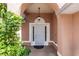 Arched front entryway featuring a decorative security door and a hanging light fixture at 2466 Candlewick St, Deltona, FL 32738