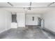 Spacious garage featuring concrete floor, water heater, and ample storage space at 2466 Candlewick St, Deltona, FL 32738