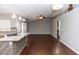 Open-concept living space with modern lighting, hardwood floors, and seamless transition to the kitchen at 2466 Candlewick St, Deltona, FL 32738