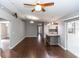 Open-concept living area showcasing hardwood floors, modern lighting, and easy access to the kitchen at 2466 Candlewick St, Deltona, FL 32738
