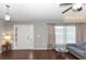 Bright living room boasts lots of natural light, hardwood floors, and neutral paint at 2466 Candlewick St, Deltona, FL 32738