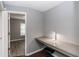 Home office with built-in desk, wood-look flooring, and natural light, adjacent to bedroom at 2466 Candlewick St, Deltona, FL 32738