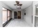 Enclosed lanai with dual ceiling fans, tile flooring, and sliding doors at 2466 Candlewick St, Deltona, FL 32738
