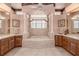 Luxurious bathroom with a jacuzzi tub, double vanities, and elegant columns at 2542 S Peninsula Dr, Daytona Beach, FL 32118