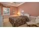 Cozy bedroom with a comfortable bed, side chair, and natural light at 2542 S Peninsula Dr, Daytona Beach, FL 32118