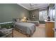 Green bedroom featuring two twin beds, green walls, and neutral colored carpet at 2542 S Peninsula Dr, Daytona Beach, FL 32118