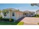 Stunning home exterior with a tile roof, manicured lawn, driveway, and three-car garage at 2542 S Peninsula Dr, Daytona Beach, FL 32118