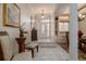 Bright foyer with white tile, front door with decorative glass, and stairs to dining room at 2542 S Peninsula Dr, Daytona Beach, FL 32118