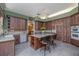 Eat-in kitchen featuring wood cabinets, an island with bar seating, and stainless steel appliances at 2542 S Peninsula Dr, Daytona Beach, FL 32118