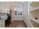Well-lit home office with built-in cabinets, hardwood floors, and a large window at 2542 S Peninsula Dr, Daytona Beach, FL 32118