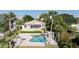 Private backyard oasis featuring a sparkling pool and lush tropical landscaping at 2542 S Peninsula Dr, Daytona Beach, FL 32118