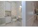 Traditional powder room with floral wallpaper, pedestal sink, and built-in cabinets at 2542 S Peninsula Dr, Daytona Beach, FL 32118