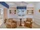 Cozy sunroom featuring waterfront views, built-in shelving, and comfortable armchairs at 2542 S Peninsula Dr, Daytona Beach, FL 32118