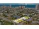 An aerial shot highlighting a property with a spacious yard, complemented by surrounding residential homes and distant ocean views at 2565 S Peninsula Dr, Daytona Beach, FL 32118