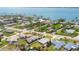 Expansive aerial view showcases a peaceful neighborhood near a tranquil bay, complete with private boat docks and lush greenery at 2565 S Peninsula Dr, Daytona Beach, FL 32118