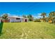 Spacious backyard with lush green grass and partial perimeter fence at 2565 S Peninsula Dr, Daytona Beach, FL 32118