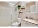 Bathroom featuring a tiled shower, updated vanity, and decor including plants and decorative shelving at 2565 S Peninsula Dr, Daytona Beach, FL 32118