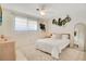 Bright bedroom with a ceiling fan, neutral walls, and decor including plants and a large mirror at 2565 S Peninsula Dr, Daytona Beach, FL 32118