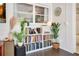 Built-in white bookshelves with books, decorations, and potted plants enhance the ambiance of the room at 2565 S Peninsula Dr, Daytona Beach, FL 32118