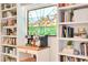 Charming coffee bar adjacent to white bookshelves with a window featuring a stained-glass pane at 2565 S Peninsula Dr, Daytona Beach, FL 32118