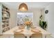Dining room features built-in bookshelves, seating for four, and a stylish pendant light at 2565 S Peninsula Dr, Daytona Beach, FL 32118