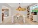 Bright dining room with stylish surfboard wall decor, bookcase, and unique stained-glass window at 2565 S Peninsula Dr, Daytona Beach, FL 32118