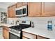 Close-up of kitchen range, white backsplash, quartz counters, and wooden cabinets at 2565 S Peninsula Dr, Daytona Beach, FL 32118
