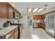 Spacious kitchen with stainless steel appliances, wooden cabinets, quartz countertops, and skylight at 2565 S Peninsula Dr, Daytona Beach, FL 32118