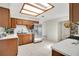 Bright kitchen with stainless steel appliances, white countertops, and wooden cabinets with skylight at 2565 S Peninsula Dr, Daytona Beach, FL 32118