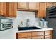 Kitchen area with stainless steel appliances, white backsplash, and wooden cabinets at 2565 S Peninsula Dr, Daytona Beach, FL 32118