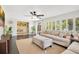 Sunlit living room features a ceiling fan, dark wood floors, and a comfortable place to relax at 2565 S Peninsula Dr, Daytona Beach, FL 32118