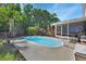 Relaxing backyard view showcasing a well-maintained pool and patio with lush landscaping at 261 Clydesdale Cir, Sanford, FL 32773