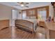 Spacious bedroom with hardwood floors, neutral walls, and large windows, and a wooden bed frame at 261 Clydesdale Cir, Sanford, FL 32773